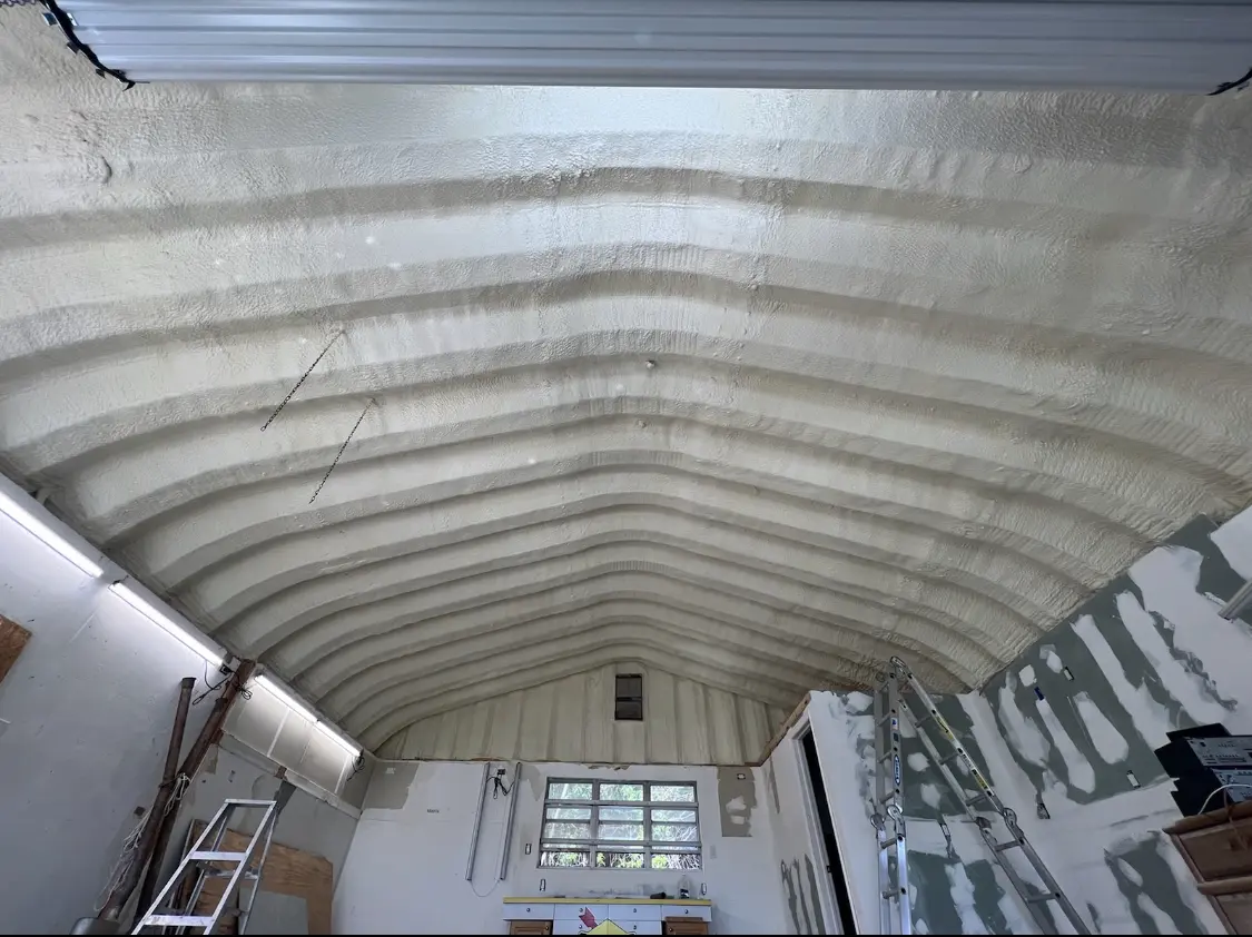 Spray polyurethane foam applied to the underside of a metal roof deck in Lowell